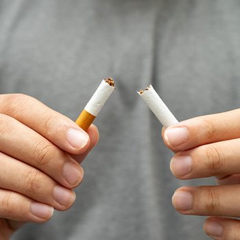 Closeup of patient breaking cigarette