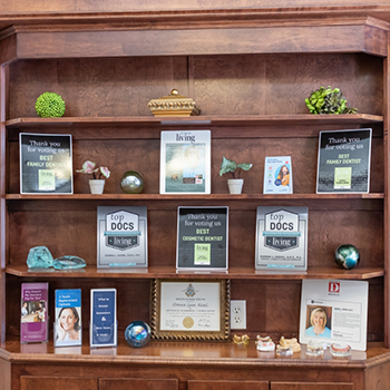 Multiple dental awards on a shelf