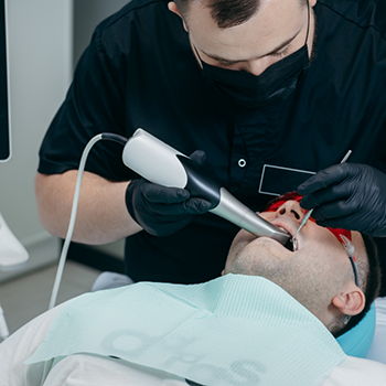 Dentist scanning a male patients mouth