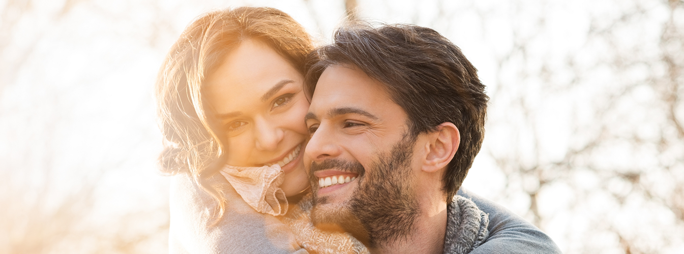 Man giving woman a piggyback ride