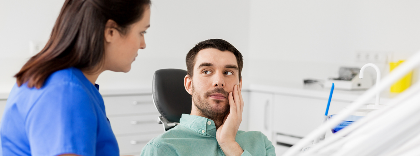 Man with toothache visiting emergency dentist in Coppell