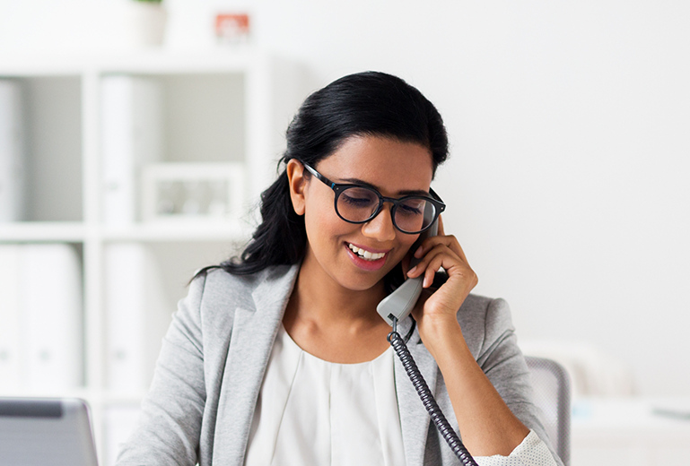 Woman with glasses speaking on the phone