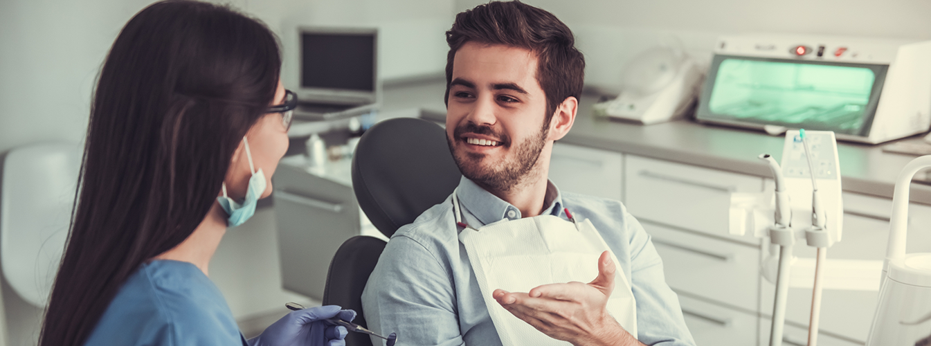 Man sitting in dental chair and smiling