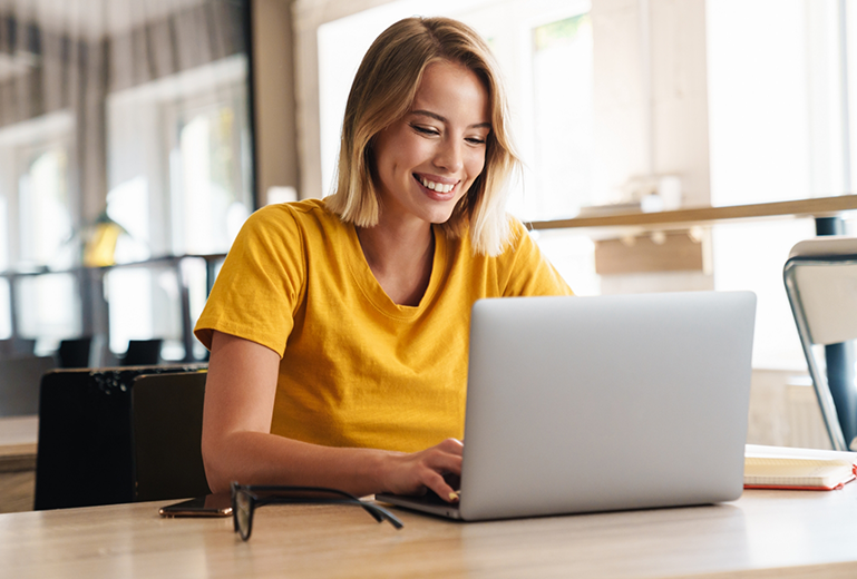 Woman sitting at desk using laptop