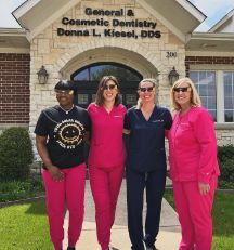 Dental team members standing outside of dental office
