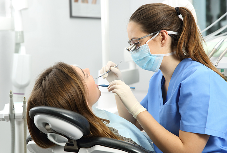 Female dentist treating a female patient