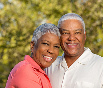 Two senior standing together outside and smiling
