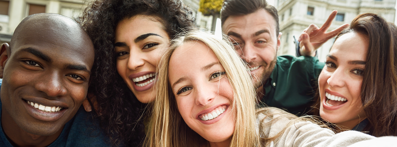 Multiple people crowded together smiling for a photo
