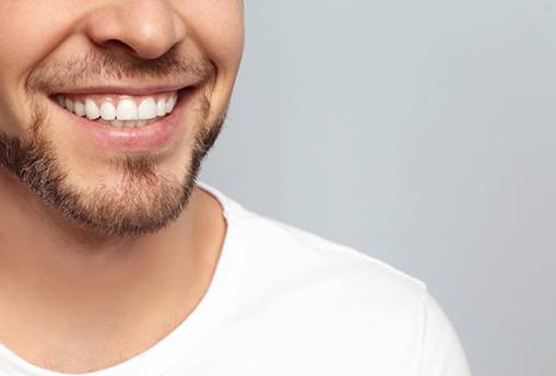 a man smiling with white teeth